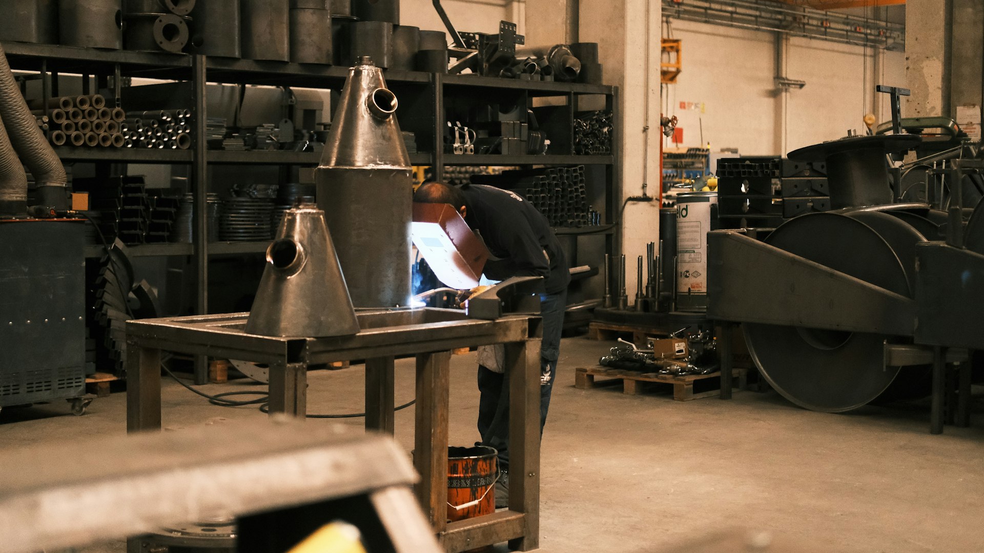 A man working on a piece of paper in a factory